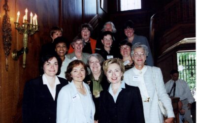 Shirley T. Joseph, standing in the third row behind Hillary Clinton